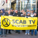 A group of workers standing outside the A-Channel headquarters, holding a sign that says "Scab TV"